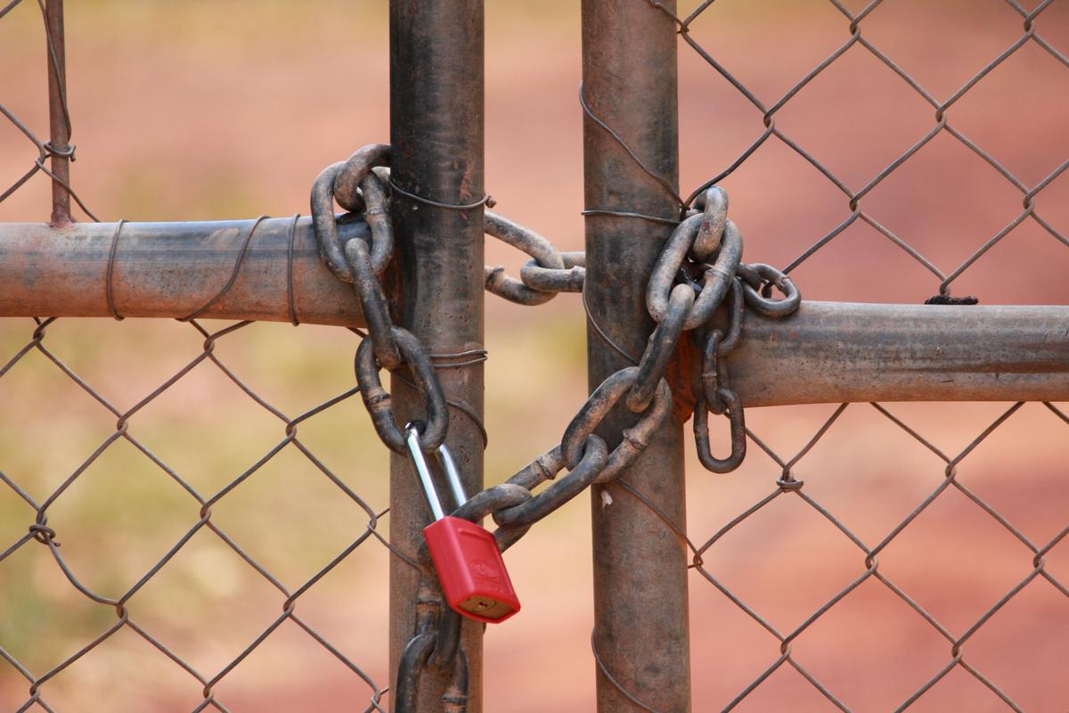 An image of a person working on a laptop with a lock icon representing cybersecurity career strategy