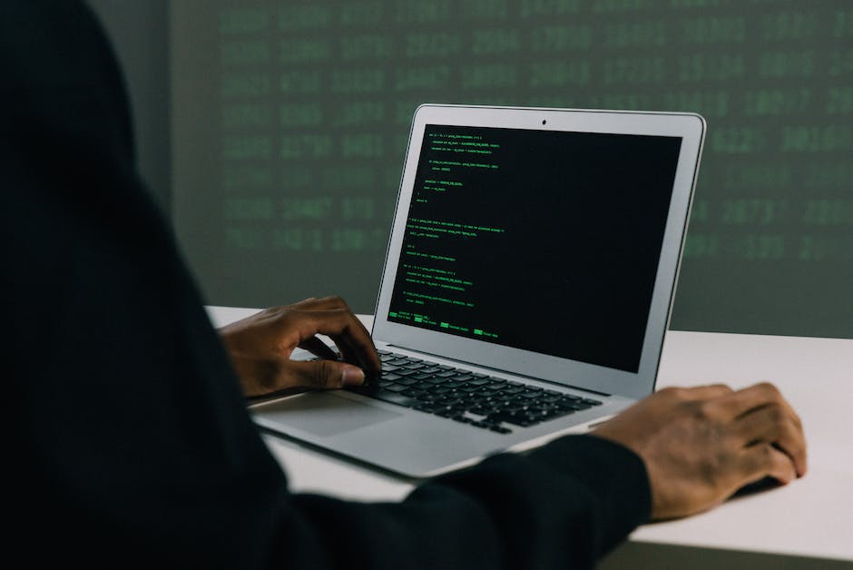 Image depicting a person wearing a suit and a digital shield symbolizing cybersecurity