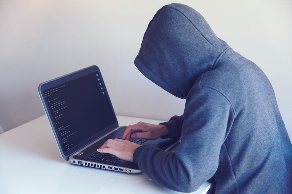 Image of a person typing on a computer keyboard with a background of binary code and locks