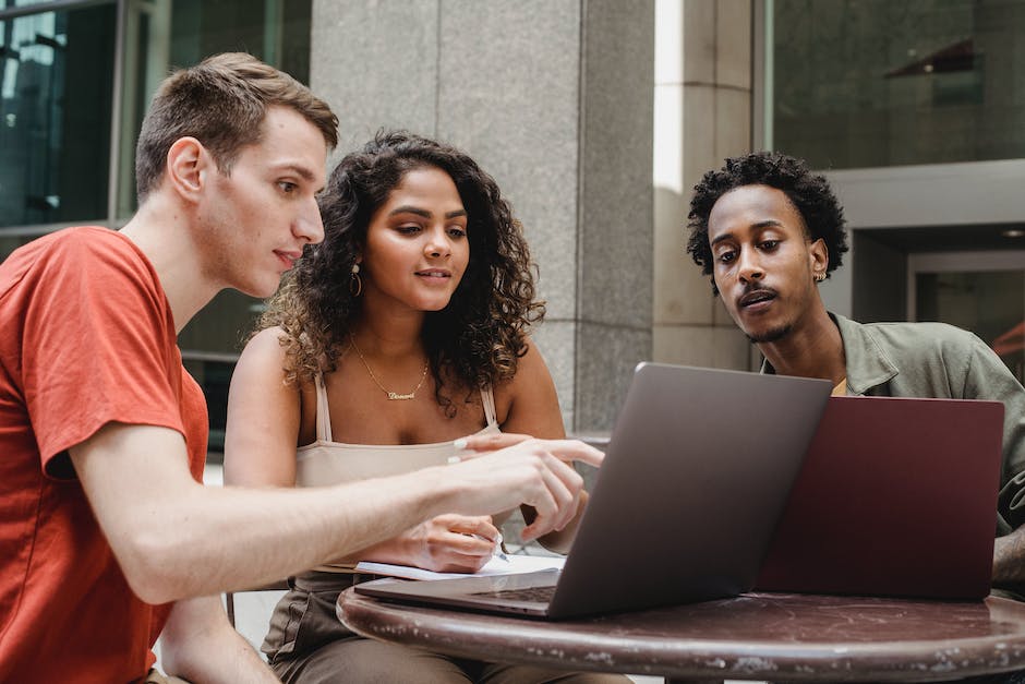 A group of diverse people working with computers in a tech industry office